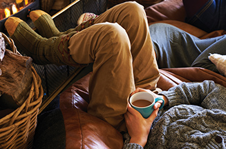 man drinking tea in cosy home