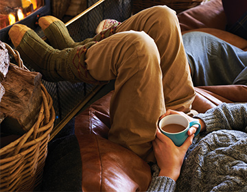 man drinking tea in cosy home