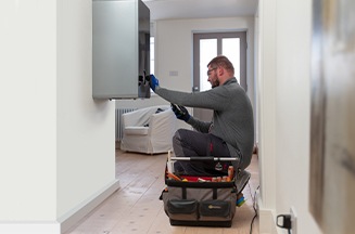 Image of an engineer servicing a boiler
