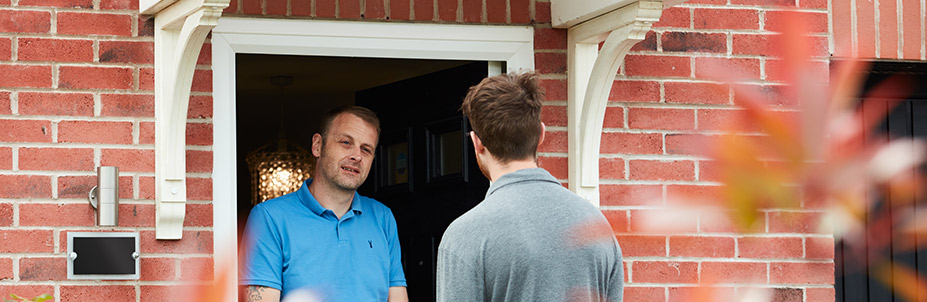 Image of an E.ON engineer being greeted at a customer door