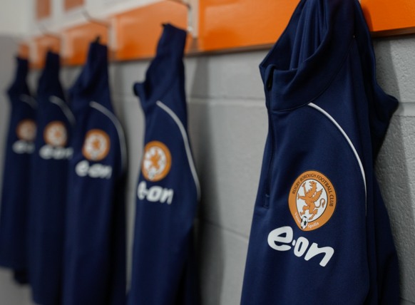 E.ON branded training shirts hung up on row of pegs